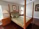 Cozy bedroom with a four-poster bed, wooden nightstands, and a tranquil ambiance at 4436 Yachtmans Ct, Orlando, FL 32812