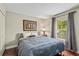 Bedroom boasts natural light from a window with modern decor and hardwood floors at 4436 Yachtmans Ct, Orlando, FL 32812