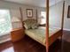 Cozy bedroom with a four-poster bed, wooden nightstands, and a tranquil ambiance at 4436 Yachtmans Ct, Orlando, FL 32812