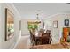 Traditional dining room with a large window and an elegant chandelier at 4436 Yachtmans Ct, Orlando, FL 32812