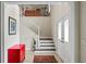 Bright foyer with stairs leading up to the second level and a red accent table at 4436 Yachtmans Ct, Orlando, FL 32812
