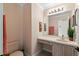 Cozy half bathroom featuring wallpaper, a vanity with sink, and a toilet at 4436 Yachtmans Ct, Orlando, FL 32812