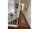 Hallway featuring hardwood floors, a decorative rug, and framed artwork on the walls at 4436 Yachtmans Ct, Orlando, FL 32812
