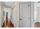 Hallway featuring pristine hardwood flooring and white doors, enhancing the home's appeal at 4436 Yachtmans Ct, Orlando, FL 32812