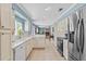 Bright kitchen boasts white cabinets, stainless steel appliances, and a seamless transition into the inviting living area at 4436 Yachtmans Ct, Orlando, FL 32812