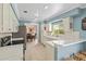 Bright, airy kitchen with stainless steel appliances, ample counter space, and cozy breakfast bar area at 4436 Yachtmans Ct, Orlando, FL 32812