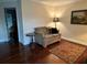Cozy living room showcasing wood floors, love seat, and artistic accents at 4436 Yachtmans Ct, Orlando, FL 32812