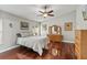Main bedroom featuring hardwood floors, ceiling fan, and a television at 4436 Yachtmans Ct, Orlando, FL 32812