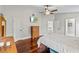 Main bedroom with hardwood floors, a ceiling fan, a television and multiple doors at 4436 Yachtmans Ct, Orlando, FL 32812