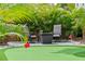 Backyard putting green surrounded by lush landscaping and patio seating offers relaxed outdoor living at 4436 Yachtmans Ct, Orlando, FL 32812
