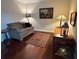 Charming sitting area with a loveseat, decorative rug, and warm lighting at 4436 Yachtmans Ct, Orlando, FL 32812