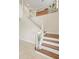 Classic staircase with white spindles and wood treads complements the bright foyer and adds architectural interest at 4436 Yachtmans Ct, Orlando, FL 32812