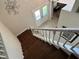 View of the staircase with dark wood steps and white railing leading to the front entrance at 4436 Yachtmans Ct, Orlando, FL 32812