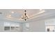 Bright bedroom with tray ceiling and a modern chandelier at 3018 Avalon Ridge Ln, Winter Garden, FL 34787