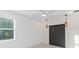 Well-lit bedroom featuring a ceiling fan and sliding barn door at 3018 Avalon Ridge Ln, Winter Garden, FL 34787