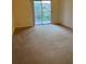 Living room area with carpeted floors and a sliding door at 5500 Metrowest Blvd # 304, Orlando, FL 32811