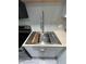 Modern kitchen sink with stainless steel fixtures and wooden cutting board at 9000 Us Highway 192 # Lot 316, Clermont, FL 34714