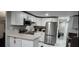 Modern kitchen with white cabinets, stainless steel appliances, and light countertops at 9000 Us Highway 192 # Lot 316, Clermont, FL 34714