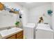 Laundry room with washer, dryer, and ample shelving at 20406 Racine St, Orlando, FL 32833