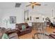 Bright living room featuring a leather couch and view into kitchen at 20406 Racine St, Orlando, FL 32833