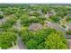 Aerial view of a house in a neighborhood with mature trees and well maintained lawns at 706 Santee Terre Ln, Winter Garden, FL 34787