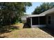 A view of the back of the home shows a large screened in lanai and spacious backyard at 1124 Chateau Cir, Minneola, FL 34715