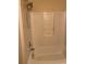 Bathroom featuring a bathtub with a shower head and white tiled walls at 1124 Chateau Cir, Minneola, FL 34715