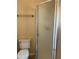 Bathroom featuring a toilet and frosted glass shower enclosure at 1124 Chateau Cir, Minneola, FL 34715