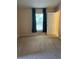 Bright, carpeted bedroom with a window and an adjacent closet, offering a cozy and functional living space at 1124 Chateau Cir, Minneola, FL 34715