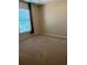 Bedroom featuring carpet, a window with blinds, and neutral colored walls at 1124 Chateau Cir, Minneola, FL 34715