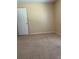 Bedroom featuring neutral carpet and a white paneled door at 1124 Chateau Cir, Minneola, FL 34715