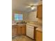 Kitchen featuring double sink, wood cabinets and countertop, and white appliances, offering functionality and charm at 1124 Chateau Cir, Minneola, FL 34715