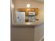 Efficient kitchen layout with appliances and breakfast bar at 1124 Chateau Cir, Minneola, FL 34715