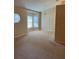 Spacious living room with neutral walls, carpet and bay windows that provide ample natural light at 1124 Chateau Cir, Minneola, FL 34715