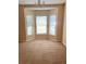 Inviting living room with neutral carpet and a bright bay window nook at 1124 Chateau Cir, Minneola, FL 34715