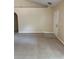 Spacious living room with carpet, neutral walls, and a vaulted ceiling with a white entry door at 1124 Chateau Cir, Minneola, FL 34715
