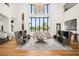 Bright living room boasts soaring ceilings, large windows, and stylish furnishings at 4029 Isabella Cir, Windermere, FL 34786