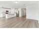 Open-concept kitchen with stainless steel appliances and bright white cabinets at 1489 Sea Glass Rd, Haines City, FL 33844