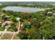 Aerial view showcasing a lakefront property with lush landscaping at 1126 Kelso Blvd, Windermere, FL 34786