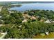 Aerial view showcasing a lakefront community with numerous homes and lush greenery at 1126 Kelso Blvd, Windermere, FL 34786