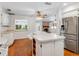 Bright kitchen with island, white cabinets, and stainless steel appliances at 1126 Kelso Blvd, Windermere, FL 34786