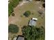 Overhead view of lot with grassy area, shed, and home with mature trees at 1879 Lake Emma Rd, Longwood, FL 32750