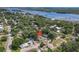 An aerial shot shows the home nestled among trees, conveniently located near a river and a bridge at 111 10Th St, New Smyrna Beach, FL 32168