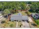 A single-story home features a well-maintained roof, a driveway, and a quaint front lawn at 111 10Th St, New Smyrna Beach, FL 32168