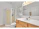 Bright bathroom features a shower, toilet, large mirror, and a vanity sink with wooden cabinets at 809 E Ridgewood St, Orlando, FL 32803