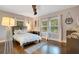 Bright bedroom features hardwood floors, neutral walls, and sun-filled windows with plantation shutters at 809 E Ridgewood St, Orlando, FL 32803