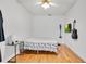 Modern bedroom featuring hardwood floors, a ceiling fan, and minimalist decor at 809 E Ridgewood St, Orlando, FL 32803