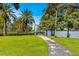 Scenic community path leading to the water, framed by lush greenery and palm trees on a sunny day at 809 E Ridgewood St, Orlando, FL 32803