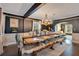Elegant dining room with a long wooden table, faux fur throws, and a decorative chandelier at 809 E Ridgewood St, Orlando, FL 32803