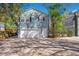 Charming blue two-story home featuring a white garage door, matching trim, and well-manicured landscaping at 809 E Ridgewood St, Orlando, FL 32803
